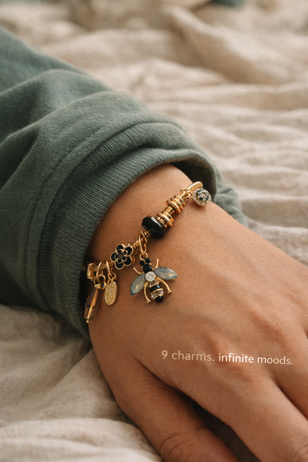 Anti-Tarnish, Ashaarya, Ashaarya Jewels, Ashaarya Jewellery,Bracelet with charms on a wrist, wearing a green sleeve.