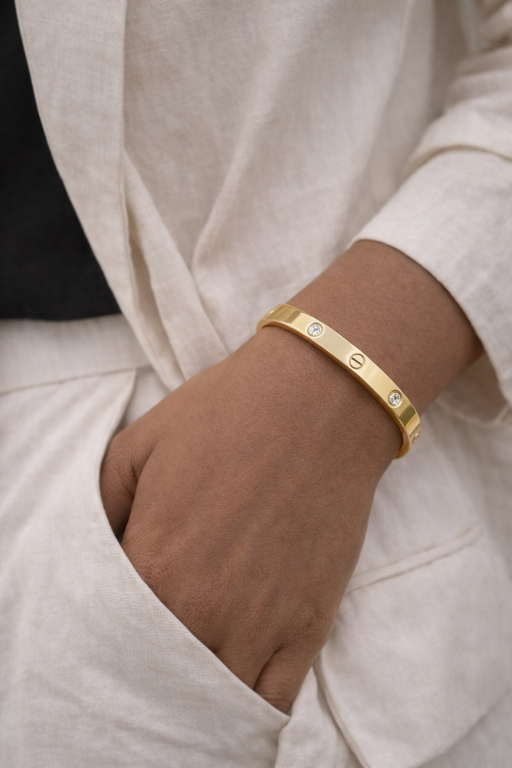 Anti-Tarnish, Ashaarya, Ashaarya Jewels, Ashaarya Jewellery, Gold bracelet on a wrist with a neutral background