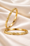 Anti-Tarnish, Ashaarya, Ashaarya Jewels, Ashaarya Jewellery,  Two gold rings with braided design on a beige fabric background