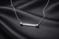 AntiTarnish, Ashaarya, Ashaarya Jewels, Ashaarya Jewellery, Silver necklace with a bar pendant on a dark fabric background
