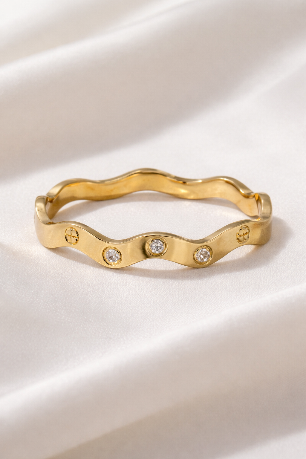 Anti-Tarnish, Ashaarya, Ashaarya Jewels, Ashaarya Jewellery, Gold ring with wavy design and embedded diamonds on a light background