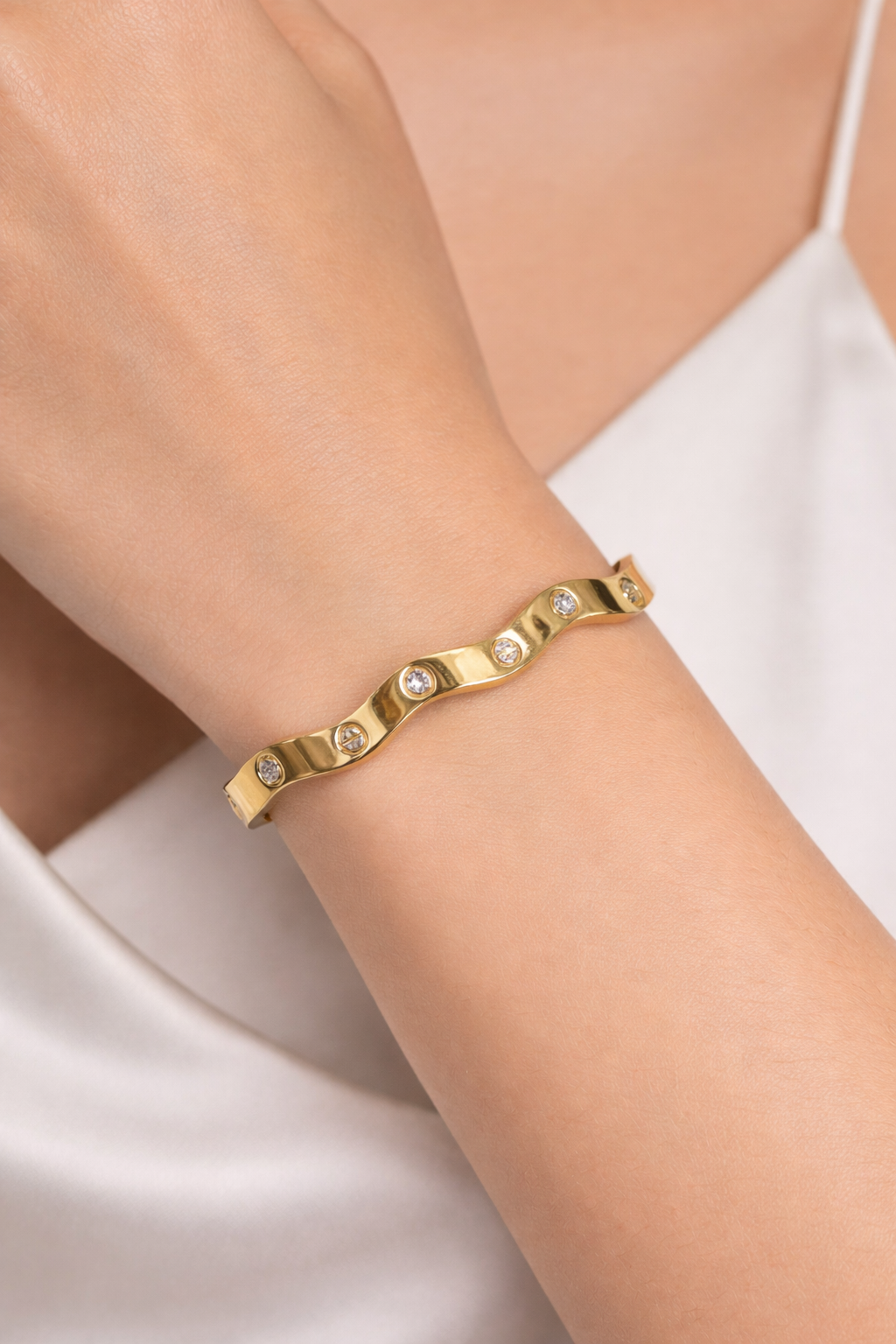 Anti-Tarnish, Ashaarya, Ashaarya Jewels, Ashaarya Jewellery, Gold bracelet with embedded stones on a wrist against a white background