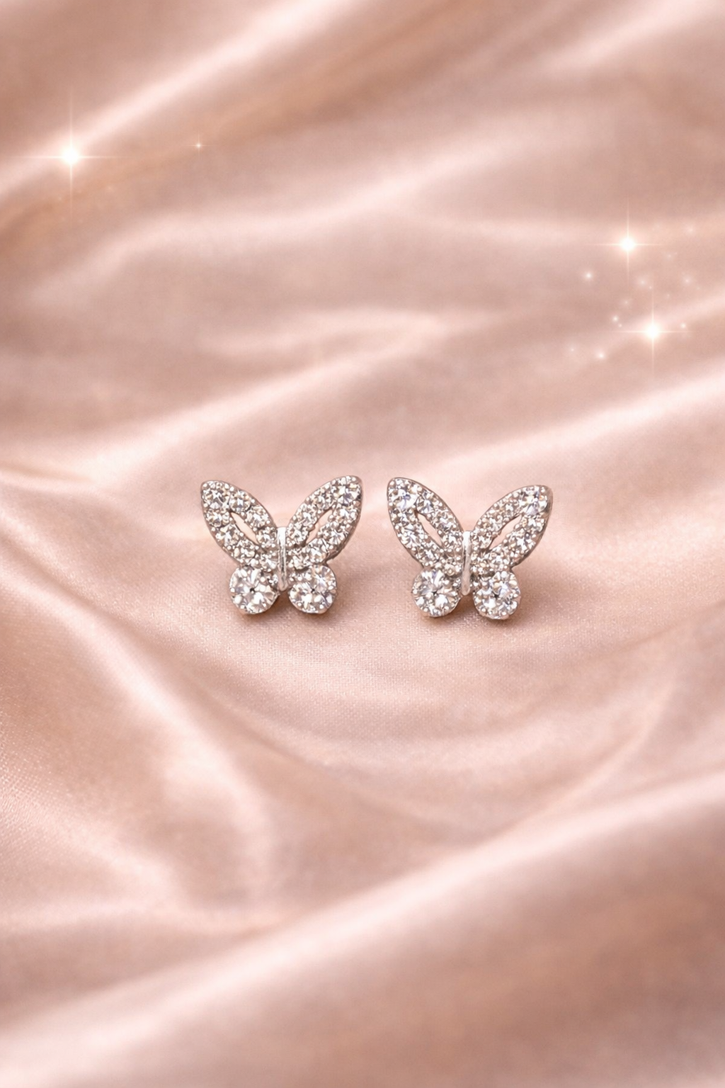 Ashaarya, Ashaarya Jewels, Ashaarya Jewellery, Butterfly-shaped earrings on a pink satin background