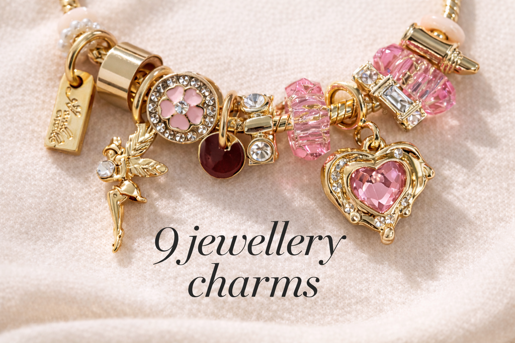 Jewellery charm bracelet with various charms on a soft pink background