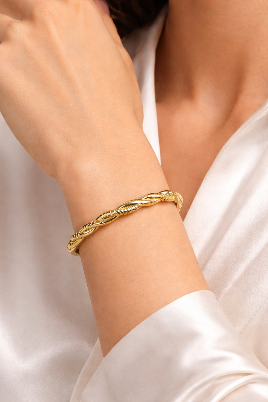 Anti-Tarnish, Ashaarya, Ashaarya Jewels, Ashaarya Jewellery, Gold bracelet on a person's wrist with a plain background
