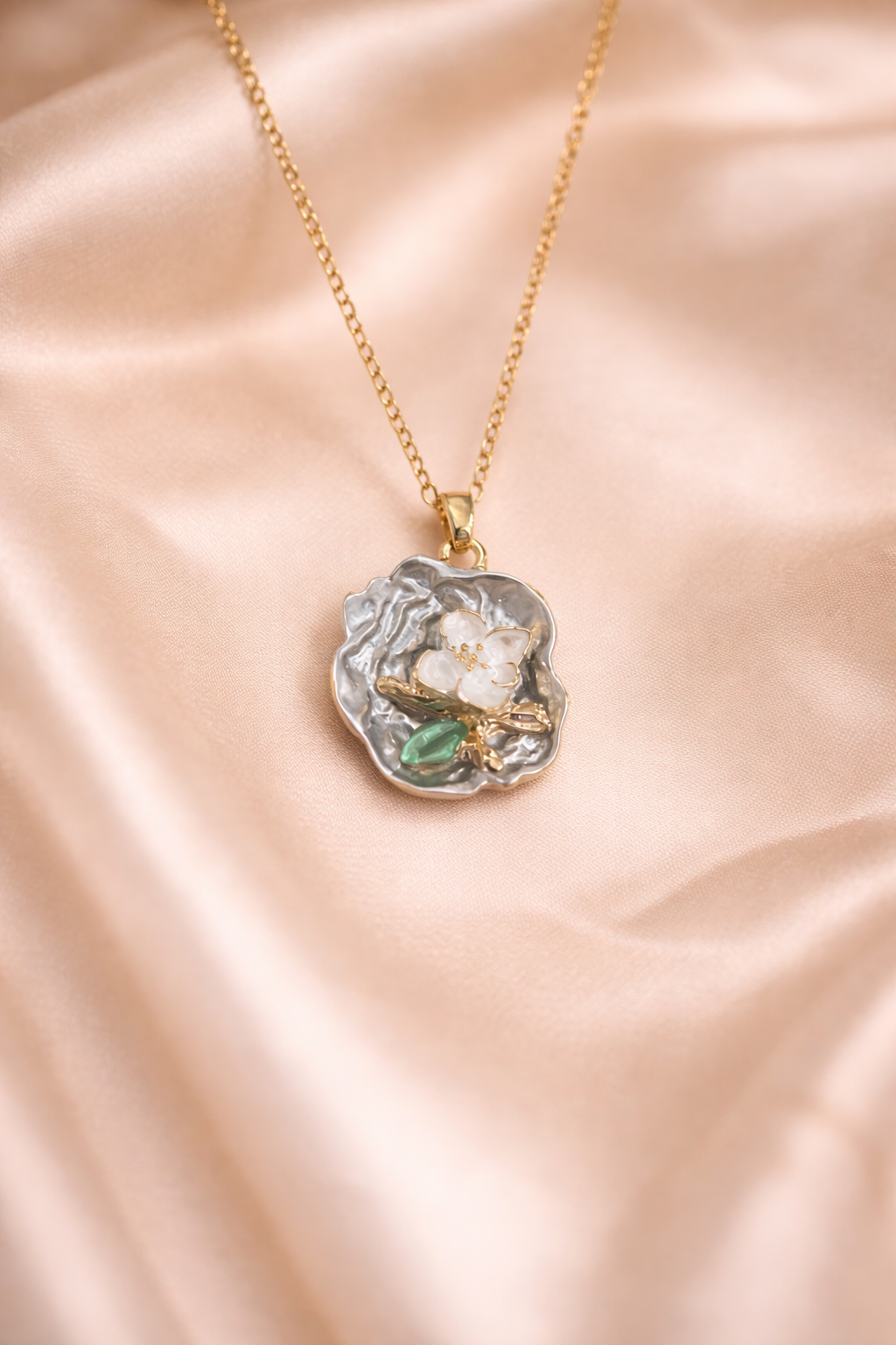 Love pearl necklace, Ashaarya, Ashaarya jewels, Ashaarya jewellery, anti-tarnish necklace with a pendant on a pink satin background