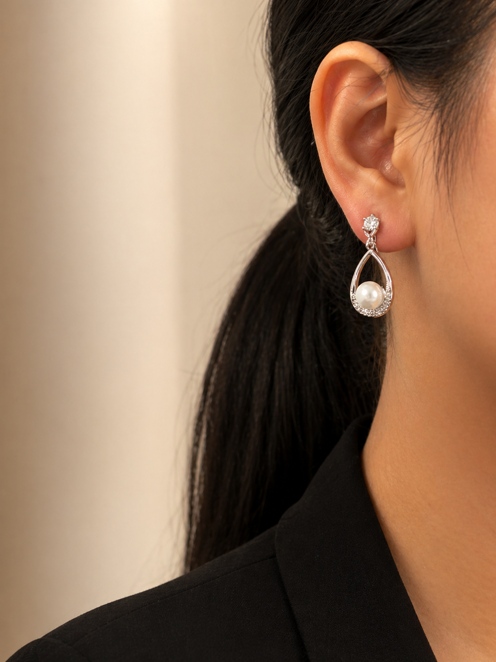 Close-up of pearl drop earrings studded with American diamonds, anti-tarnish lightweight dangling earrings