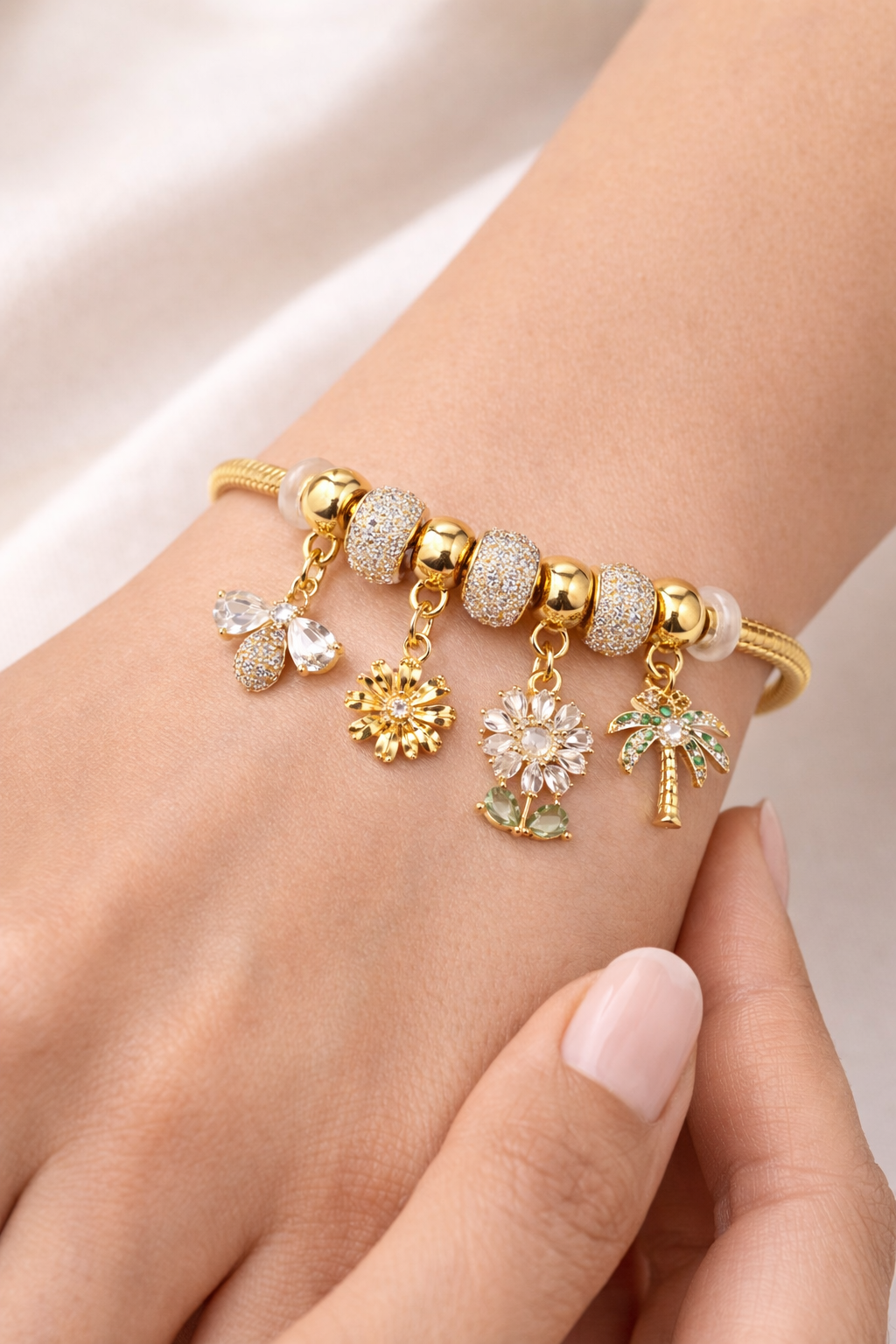 Anti-tarnish charm bracelet for women with butterfly, flower and palm charms in 18KT gold tone with American diamonds – comfort jewellery by Ashaarya