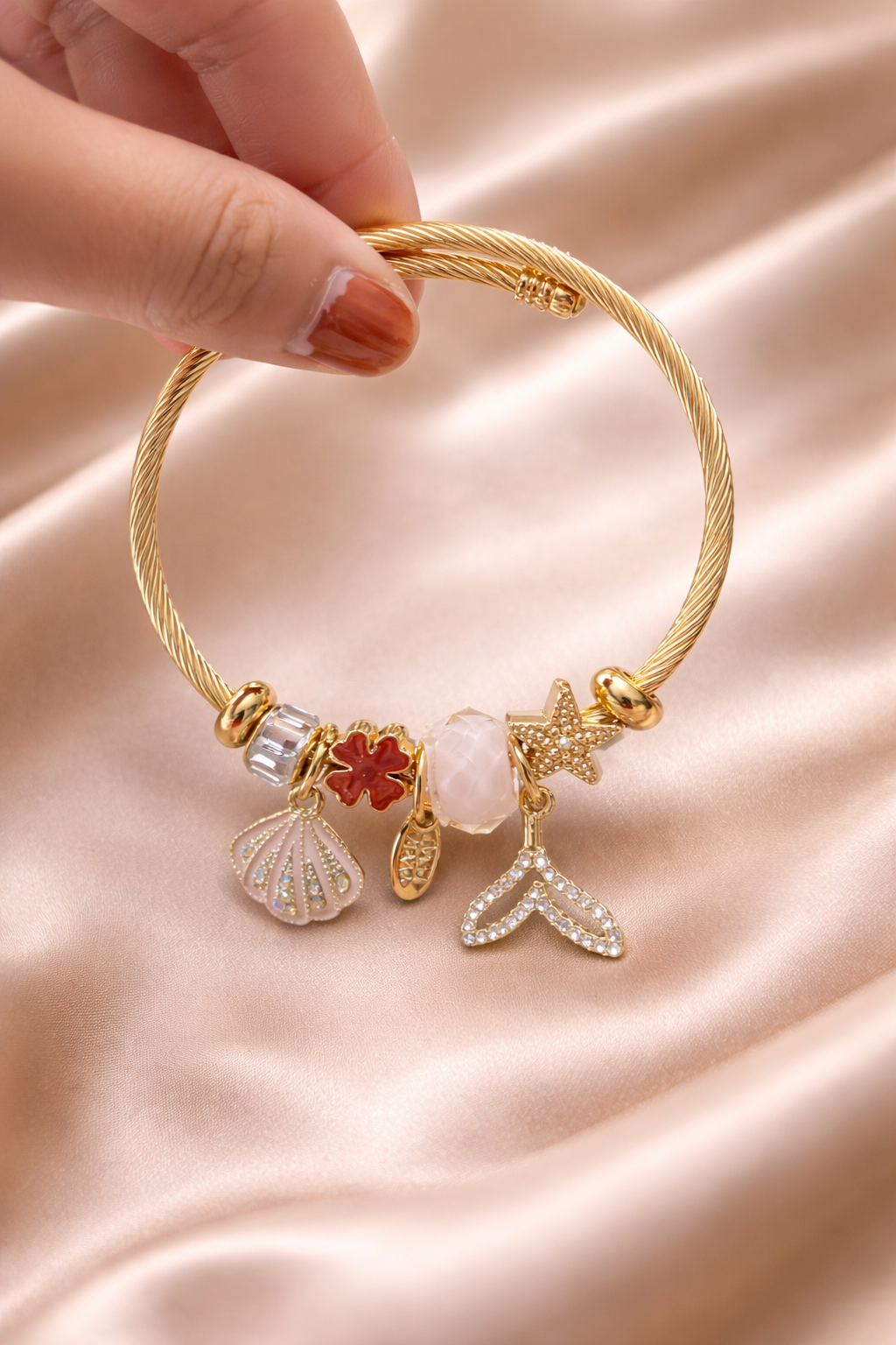 Anti-tarnish charm bracelets for women by Ashaarya featuring shell, clover, rose quartz, starfish and mermaid tail charms designed as lightweight demi-fine comfort jewellery.