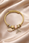 Anti-tarnish charm bracelets for women by Ashaarya featuring shell, clover, rose quartz, starfish and mermaid tail charms designed as lightweight demi-fine comfort jewellery.