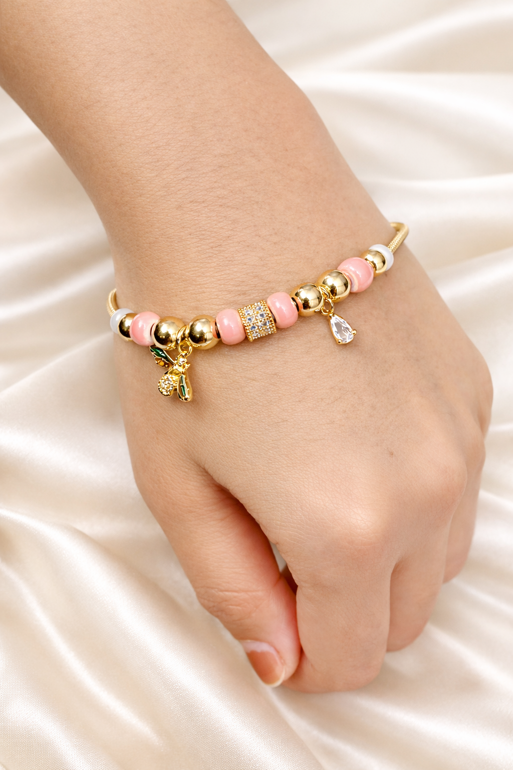 Anti-tarnish comfort jewellery charm bracelet for women with butterfly charm, pink beads and American diamonds in 18KT gold tone – demi-fine charm bracelets jewellery by Ashaarya