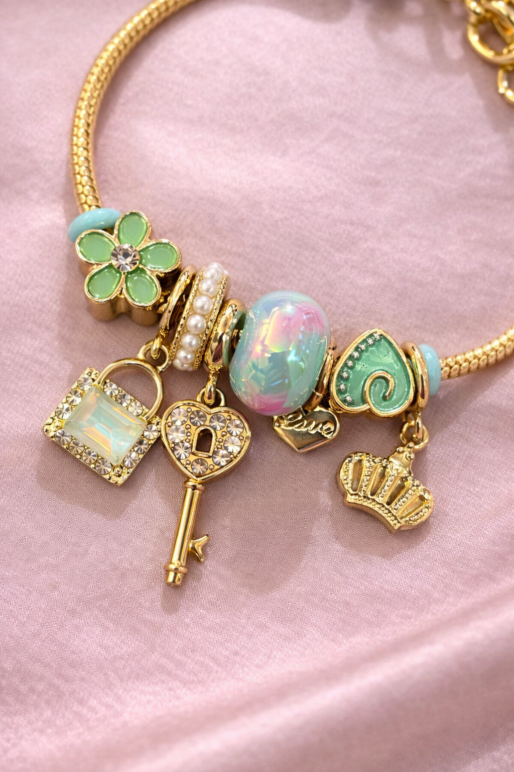 Anti-tarnish charm bracelets for women with green clover, opal bead and crown charms in gold plated demi-fine comfort jewellery by Ashaarya.