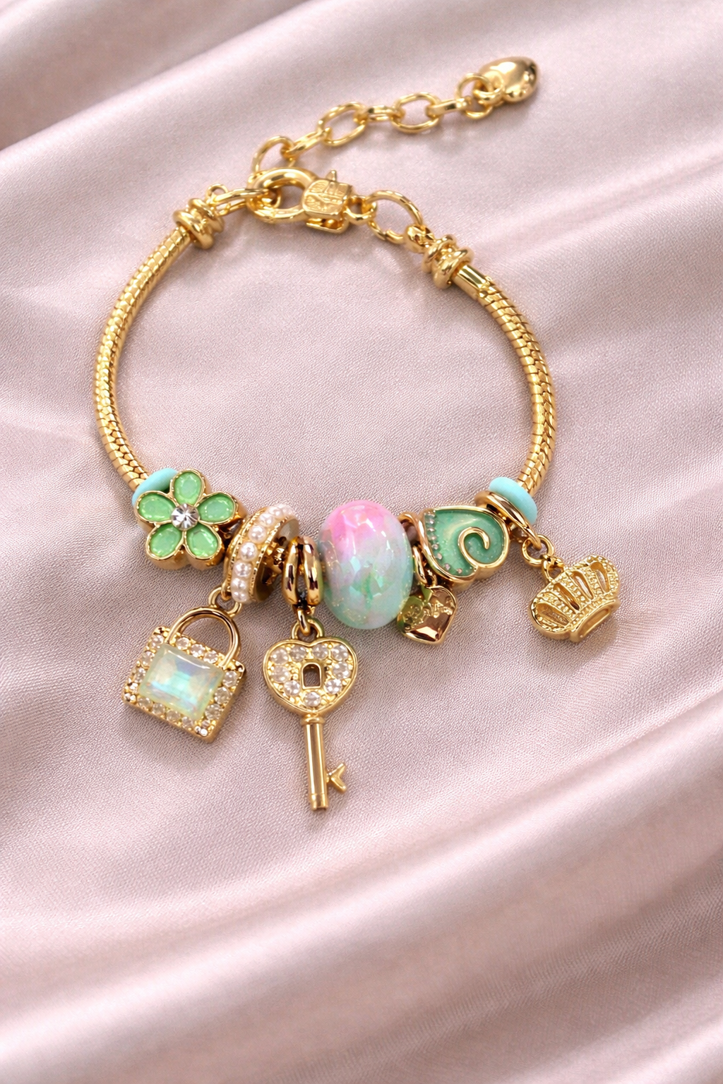 Anti-tarnish charm bracelets for women with green clover, opal bead and crown charms in gold plated demi-fine comfort jewellery by Ashaarya.