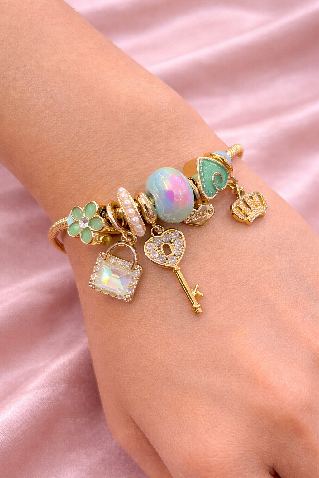 Anti-tarnish charm bracelets for women with green clover, opal bead and crown charms in gold plated demi-fine comfort jewellery by Ashaarya.