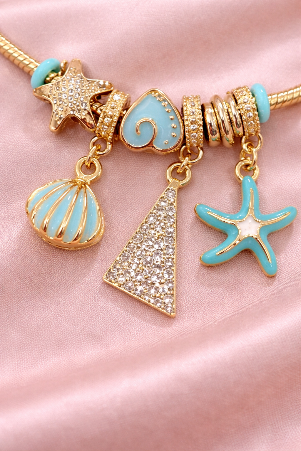Anti-tarnish comfort jewellery charm bracelets for women featuring ocean charms, turquoise starfish, seashell and crystal charms in gold plated demi-fine jewellery.