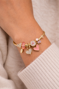 Anti-tarnish demi-fine charm bracelet for women with pink heart charms and crystal charms placed on satin background, lightweight comfort jewellery by Ashaarya