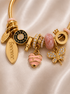Detailed view of Blush Forever Charm Bracelet by Ashaarya, lightweight anti-tarnish comfort jewellery.. charm bracelet, pink charm bracelet, heart charm bracelet, butterfly charm bracelet, gold charm bracelet for women, anti tarnish jewellery, 316L stainless steel jewellery, lightweight bracelet, skin friendly jewellery, adjustable bracelet, everyday bracelet, demi fine jewellery, comfort jewellery, luxury charm bracelet, Ashaarya charm bracelet