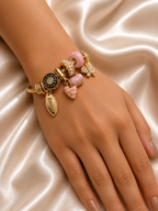 Blush Forever Charm Bracelet by Ashaarya featuring pink heart charm and 18KT gold tone finish. charm bracelet, pink charm bracelet, heart charm bracelet, butterfly charm bracelet, gold charm bracelet for women, anti tarnish jewellery, 316L stainless steel jewellery, lightweight bracelet, skin friendly jewellery, adjustable bracelet, everyday bracelet, demi fine jewellery, comfort jewellery, luxury charm bracelet, Ashaarya charm bracelet
