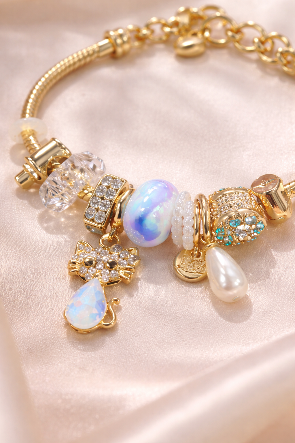 Anti-Tarnish, Ashaarya, Ashaarya Jewels, Ashaarya Jewellery,Gold bracelet with various charms on a soft pink background