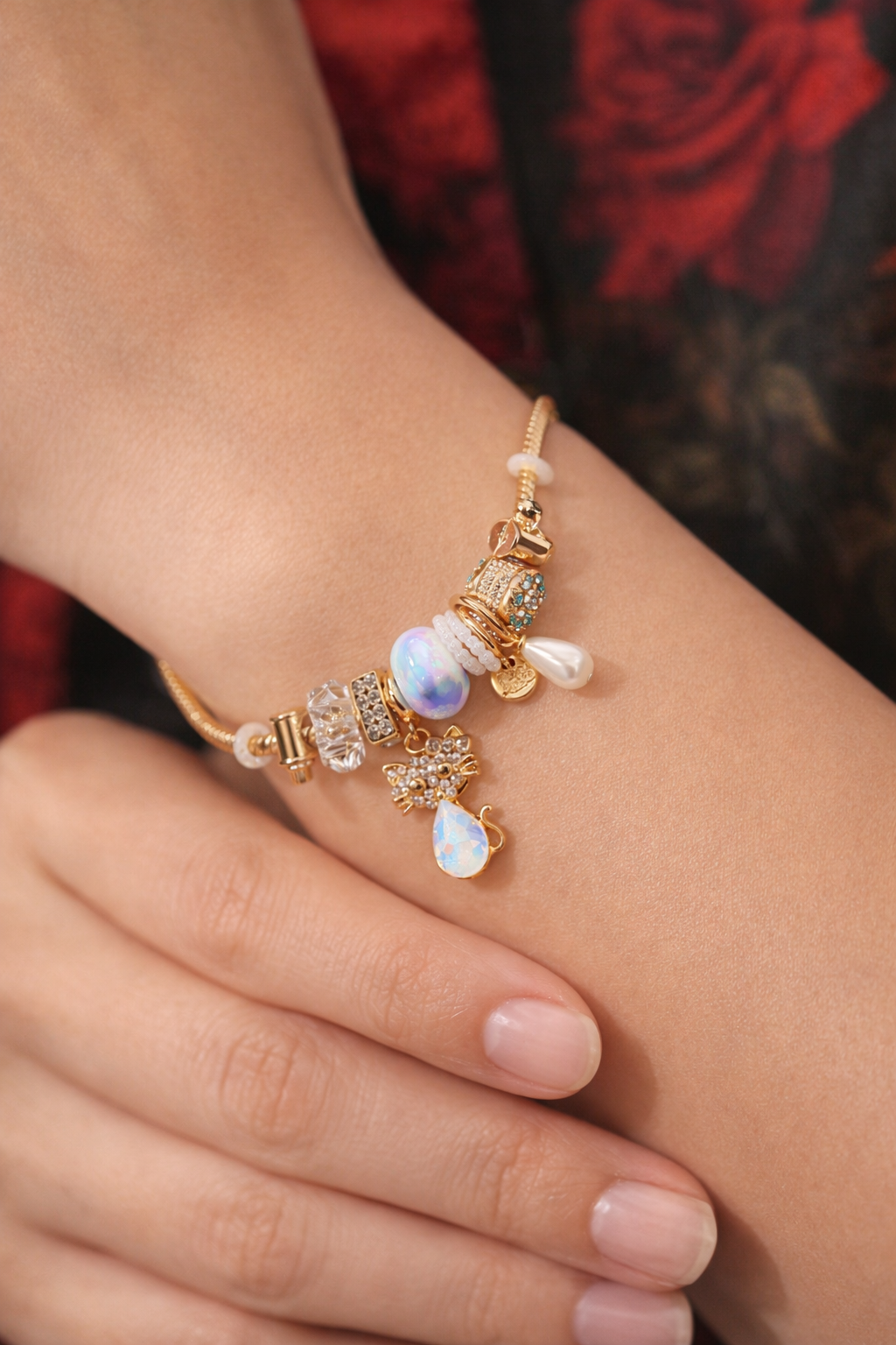 Anti-Tarnish, Ashaarya, Ashaarya Jewels, Ashaarya Jewellery,Delicate bracelet with pearls and gemstones on a wrist against a red fabric background