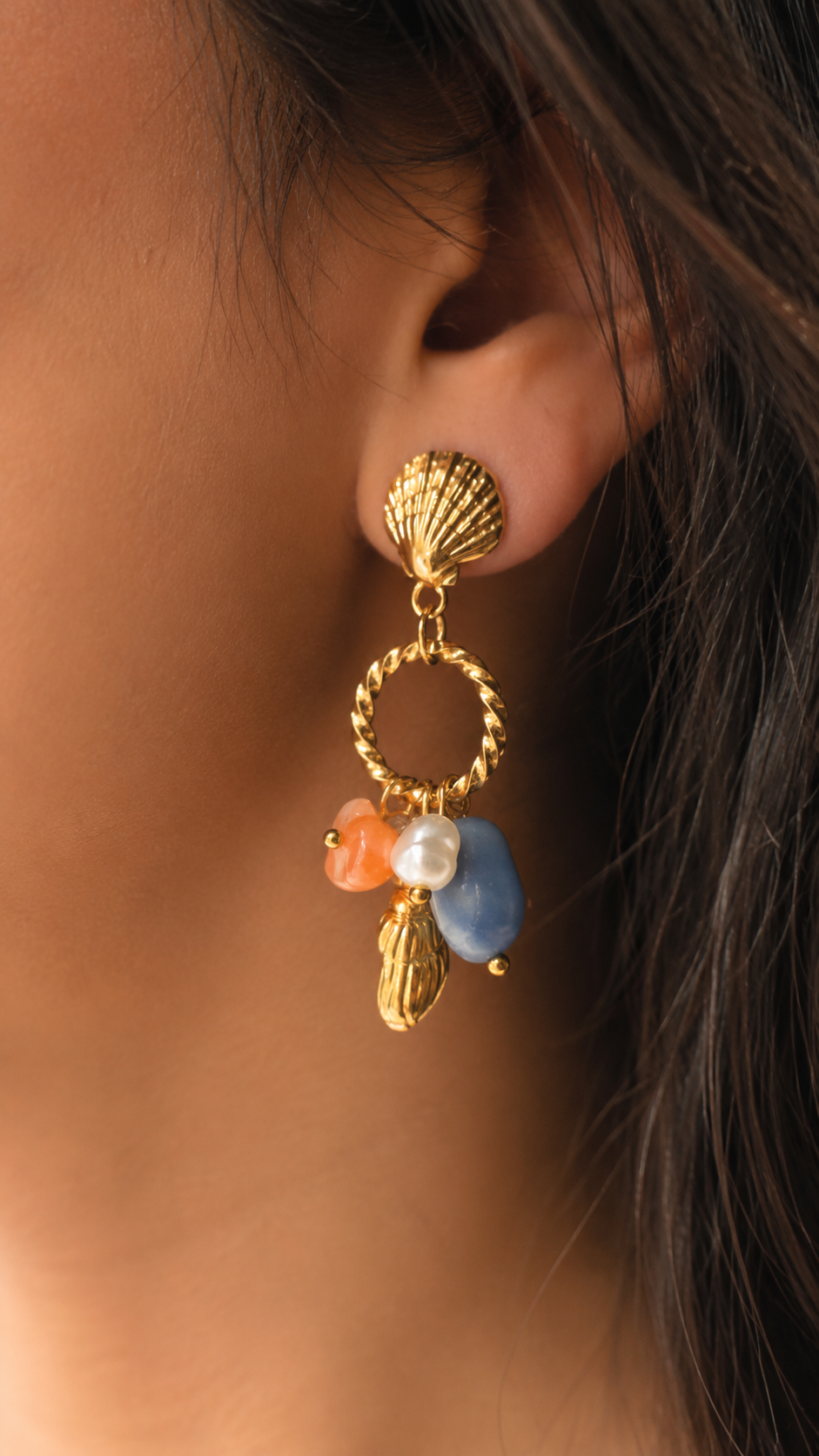 Gold tone ocean-inspired dangling earrings with heart pearl and blue stone charms for women