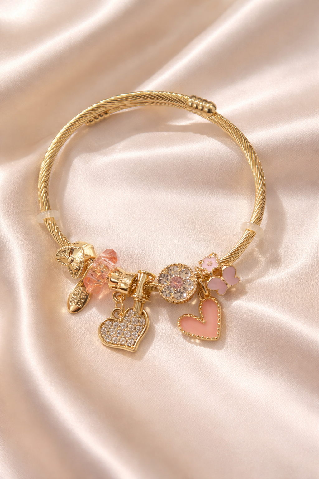 Woman wearing anti-tarnish charm bracelets for women with pink charms, lightweight demi-fine charm bracelets jewellery designed for everyday comfort jewellery