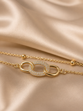 Interlink Dual Chain Bracelet by Ashaarya featuring a crystal-studded interlocking link in 18KT gold plated 316L stainless steel. Lightweight, anti-tarnish bracelet for women.