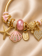 pink charm bracelet, ocean charm bracelet, beach charm bracelet, gold charm bracelet for women, seashell charm bracelet, turtle charm bracelet, 18KT gold plated bracelet, anti tarnish bracelet, stainless steel charm bracelet, lightweight charm bracelet, hypoallergenic bracelet, aesthetic charm bracelet, vacation jewellery, women's charm bracelet, Ashaarya charm bracelet
