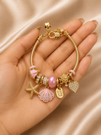 pink charm bracelet, ocean charm bracelet, beach charm bracelet, gold charm bracelet for women, seashell charm bracelet, turtle charm bracelet, 18KT gold plated bracelet, anti tarnish bracelet, stainless steel charm bracelet, lightweight charm bracelet, hypoallergenic bracelet, aesthetic charm bracelet, vacation jewellery, women's charm bracelet, Ashaarya charm bracelet