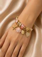 pink charm bracelet, ocean charm bracelet, beach charm bracelet, gold charm bracelet for women, seashell charm bracelet, turtle charm bracelet, 18KT gold plated bracelet, anti tarnish bracelet, stainless steel charm bracelet, lightweight charm bracelet, hypoallergenic bracelet, aesthetic charm bracelet, vacation jewellery, women's charm bracelet, Ashaarya charm bracelet