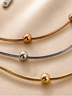 Trio Harmony Necklace by Ashaarya featuring 18KT gold tone, silver tone and rose gold tone layered beaded chains crafted in anti-tarnish 316L stainless steel.