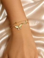 Whispering Wings Bracelet by Ashaarya featuring a dual-chain butterfly design with marquise stones, crafted in 18KT gold plating over 316L stainless steel for lightweight everyday wear.